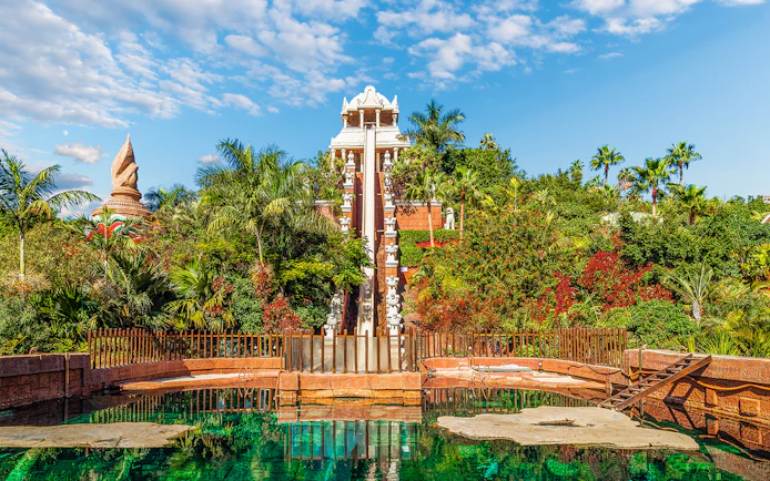 Tower of Power water slide at Siam Park, surrounded by lush greenery, Tenerife, Spain.