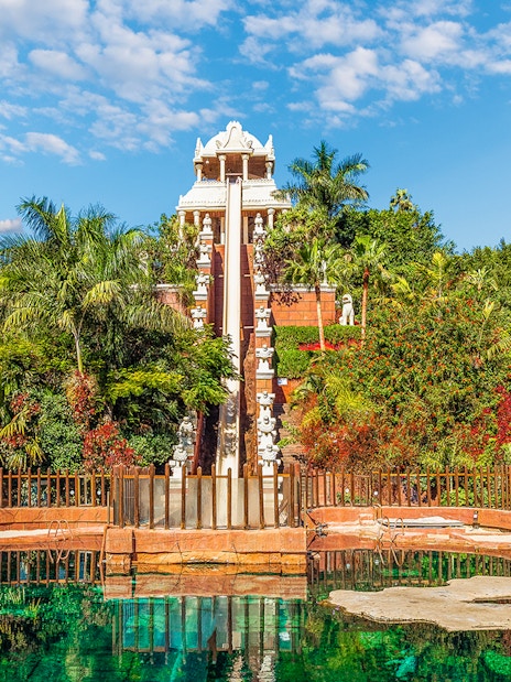 Tower of Power water slide at Siam Park, surrounded by lush greenery, Tenerife, Spain.