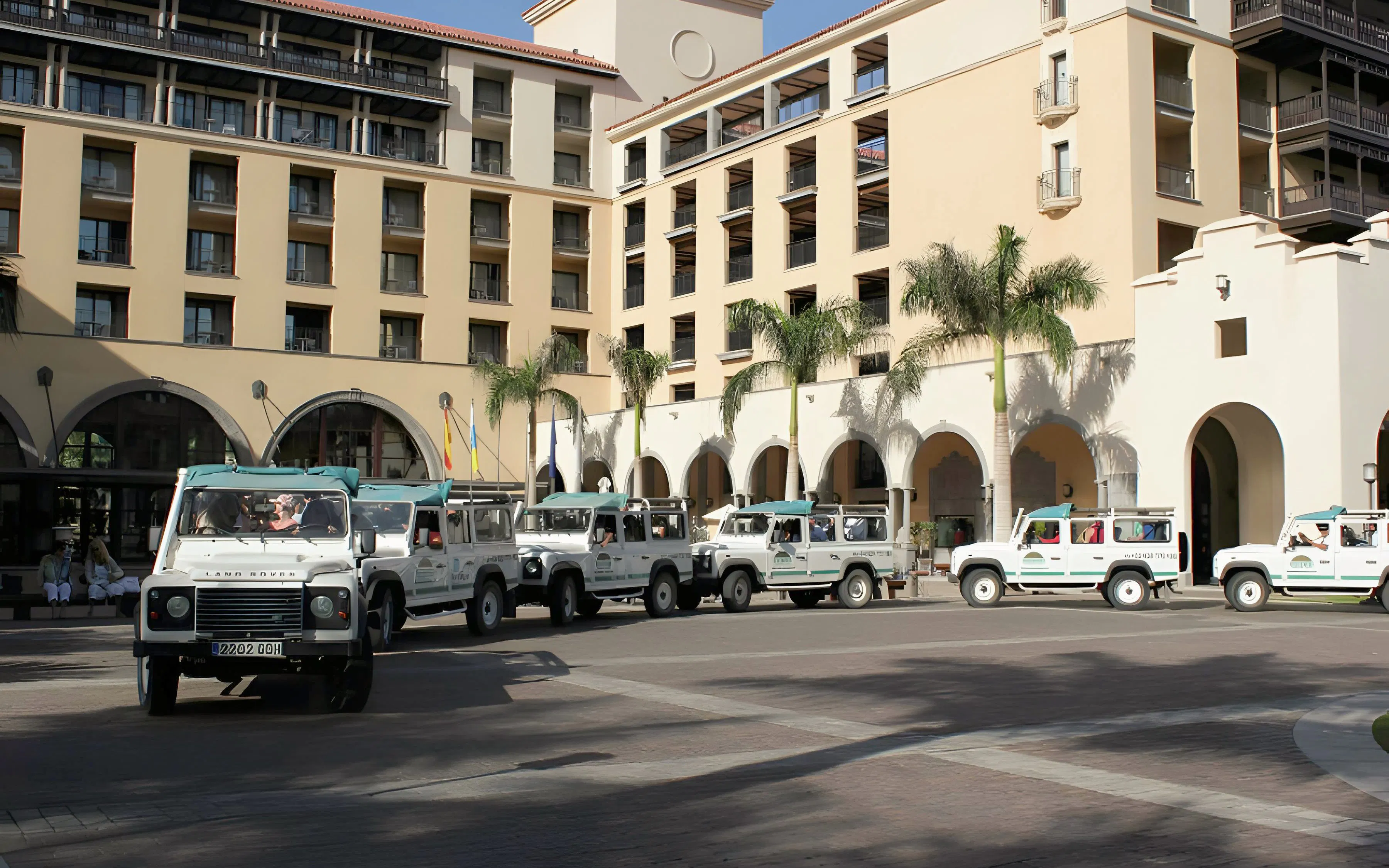 Jeep convoy ready for safari tour in Gran Canaria courtyard.