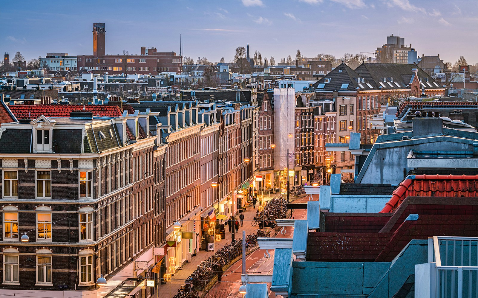 Street view of De Pijp neighborhood with traditional buildings in Amsterdam, Netherlands.