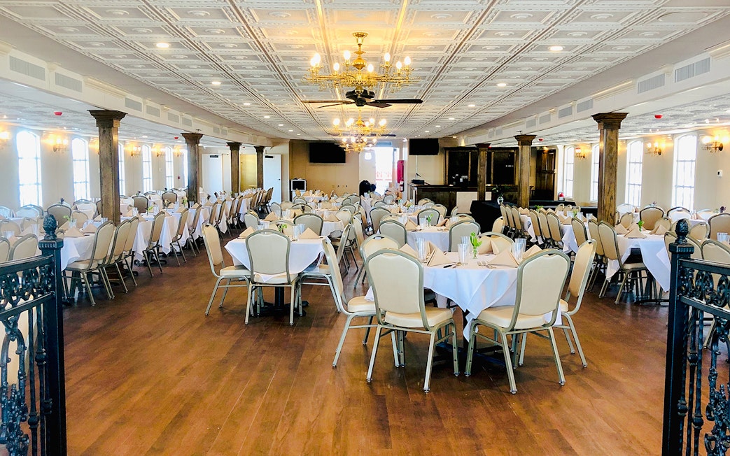 Interior dining area of CITY of NEW ORLEANS Riverboat with set tables and chandeliers.