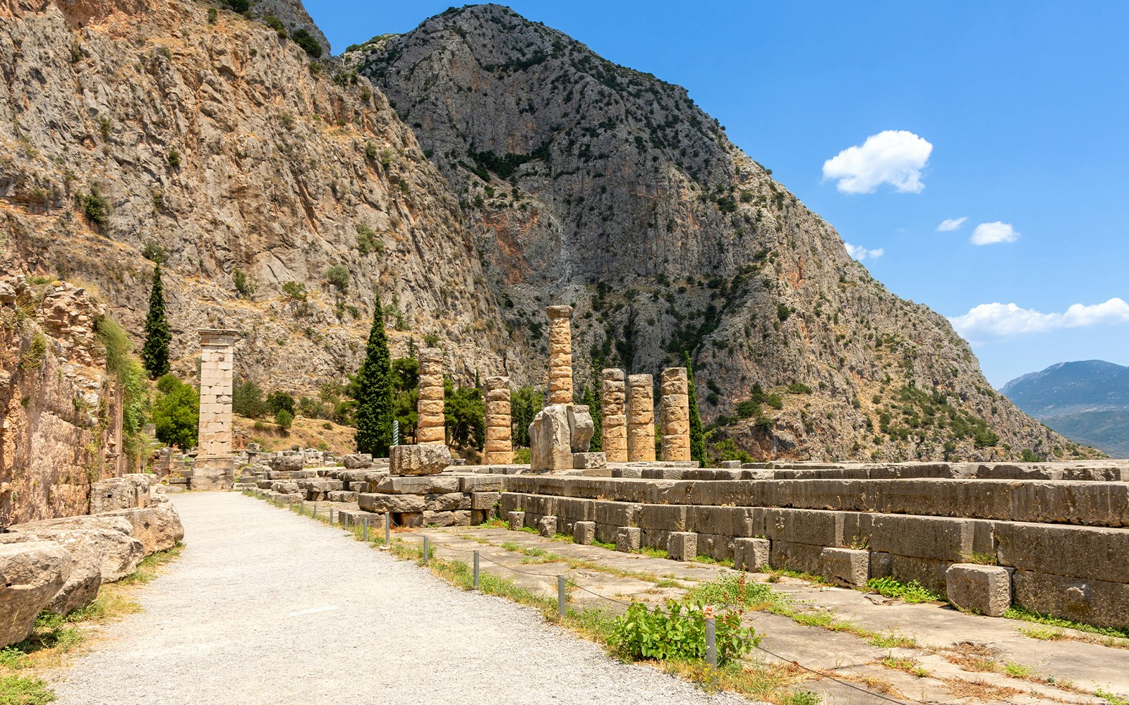 Ruins of the Temple of Apollo with mountain backdrop, Delphi, Greece.