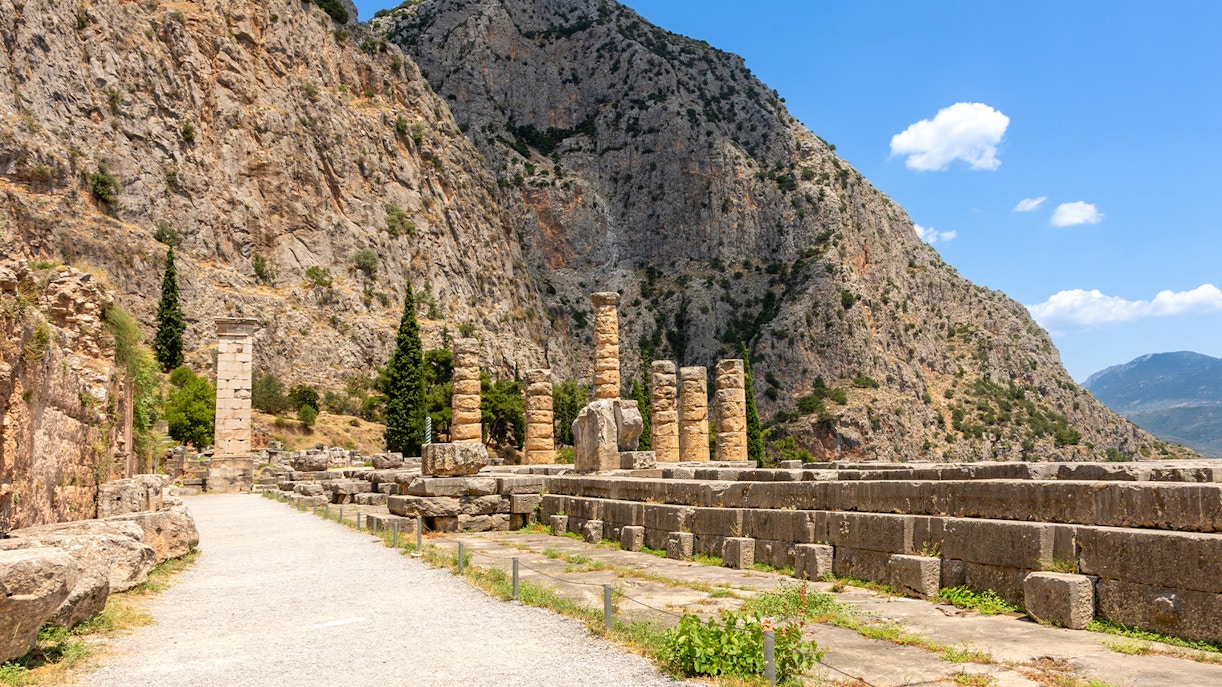 Ruins of the Temple of Apollo with mountain backdrop, Delphi, Greece.