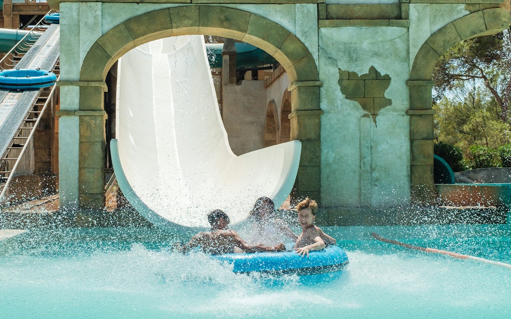 Visitors enjoying a water slide at Misol-Ah Aqualand El Arenal.