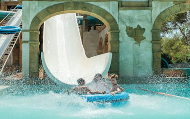 Visitors enjoying a water slide at Misol-Ah Aqualand El Arenal.