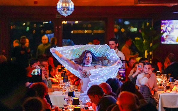 Belly dancer performing on Bosphorus dinner cruise with live entertainment.