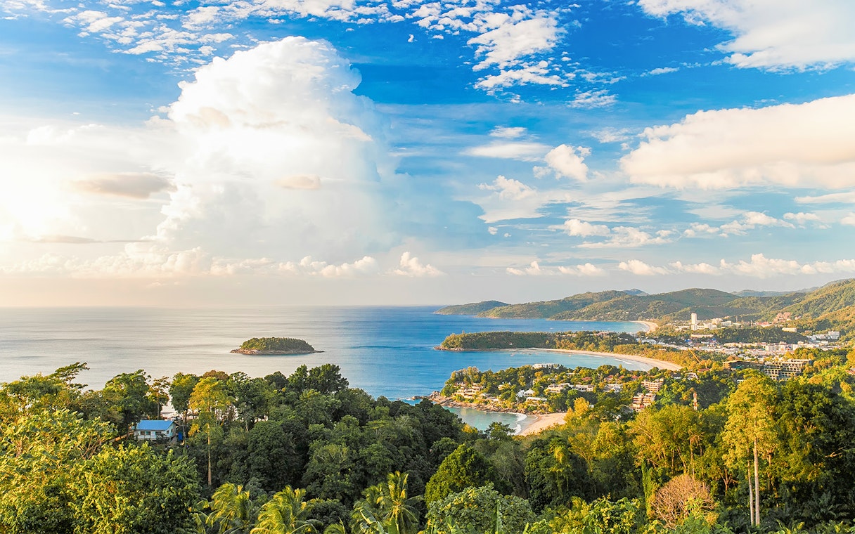 Phuket coastline with lush greenery and ocean view, ideal for ATV and zipline adventure.
