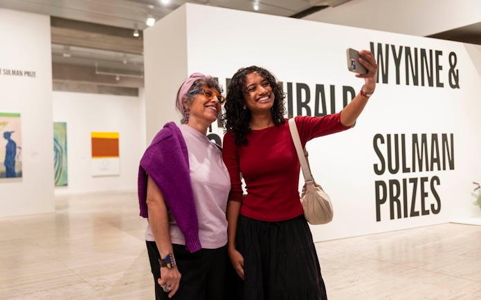 Women taking a selfie at Archibald, Wynne & Sulman Prizes, Art Gallery of New South Wales, Sydney.