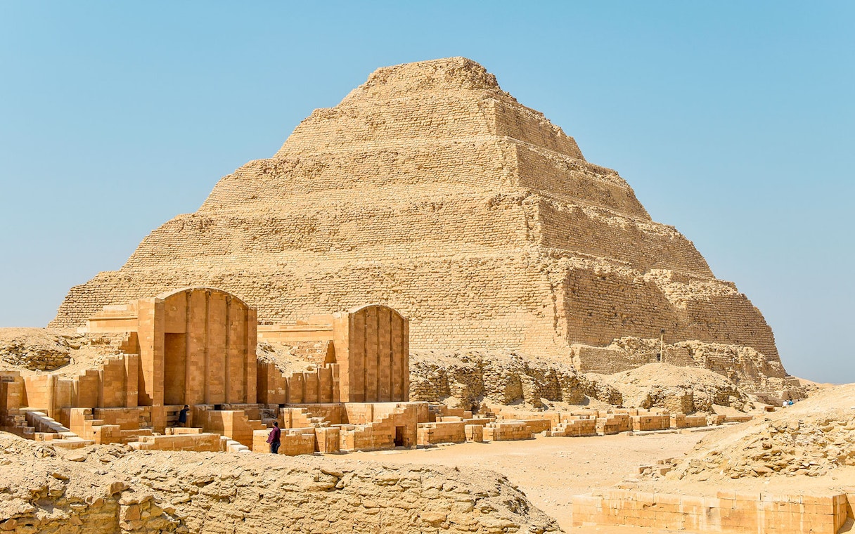 Step Pyramid of Djoser at Saqqara, Egypt under a clear sky.