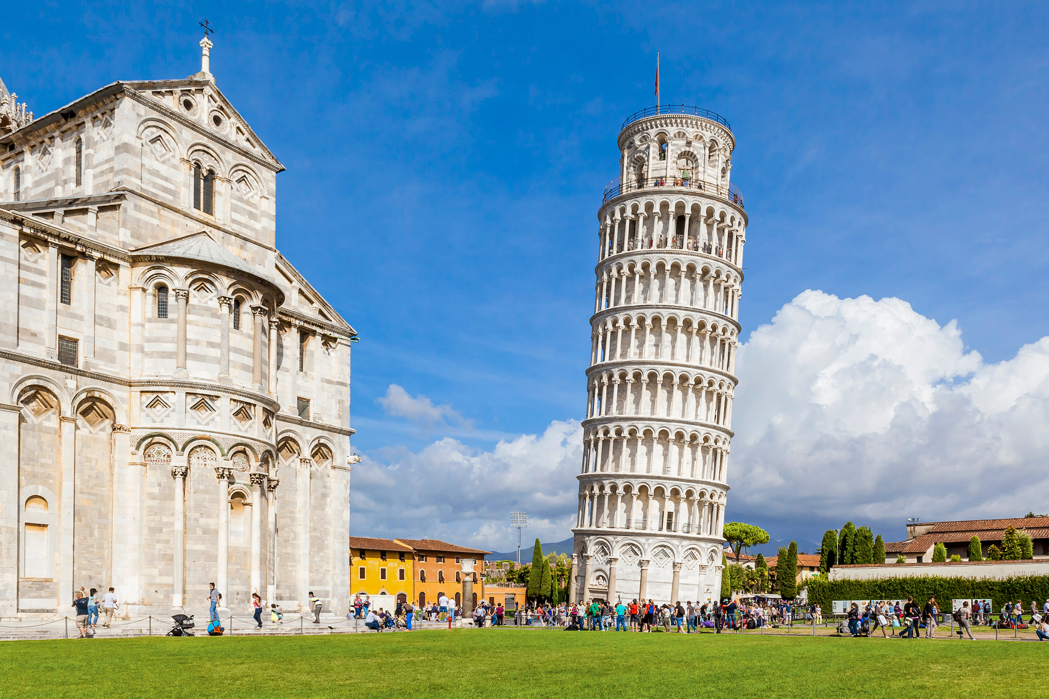Leaning Tower of Pisa with tourists in Piazza dei Miracoli, Italy.