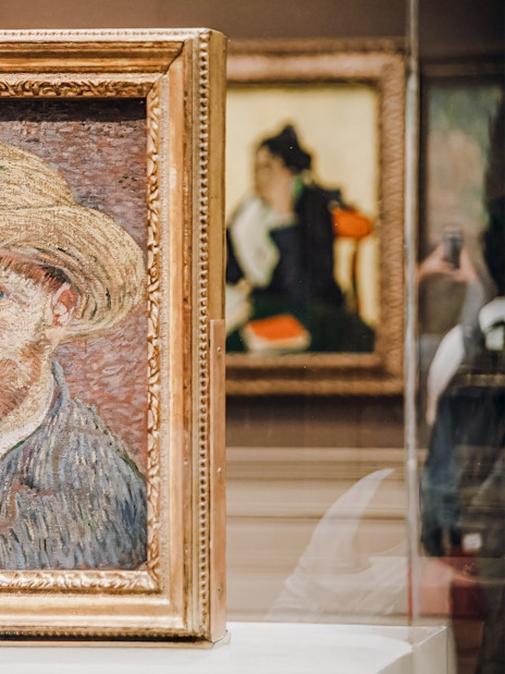 Vincent van Gogh's self-portrait with straw hat in gold frame at Metropolitan Museum of Art.