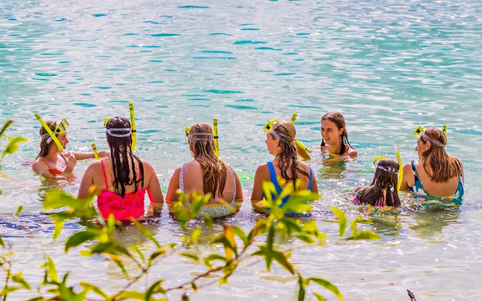 Tourists snorkeling in clear waters at K'gari, Fraser Island.