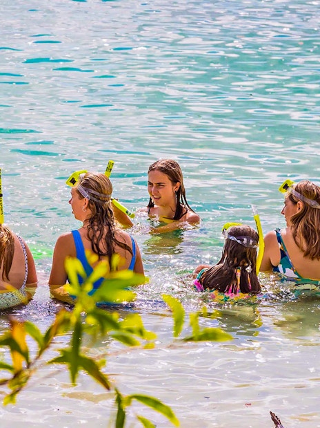 Tourists snorkeling in clear waters at K'gari, Fraser Island.