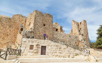 Ajloun Castle stone walls and towers under a clear sky in Jordan.