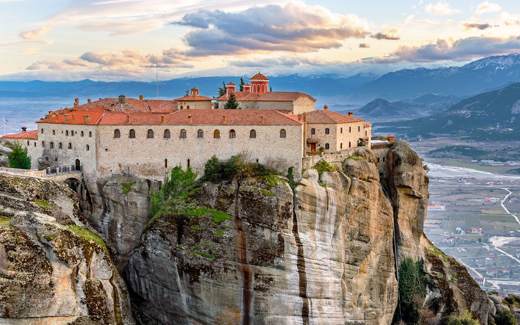 Meteora monastery perched on rock formation, view from 1-day train tour from Athens.