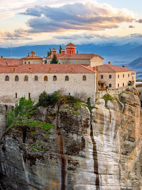 Meteora monastery perched on rock formation, view from 1-day train tour from Athens.