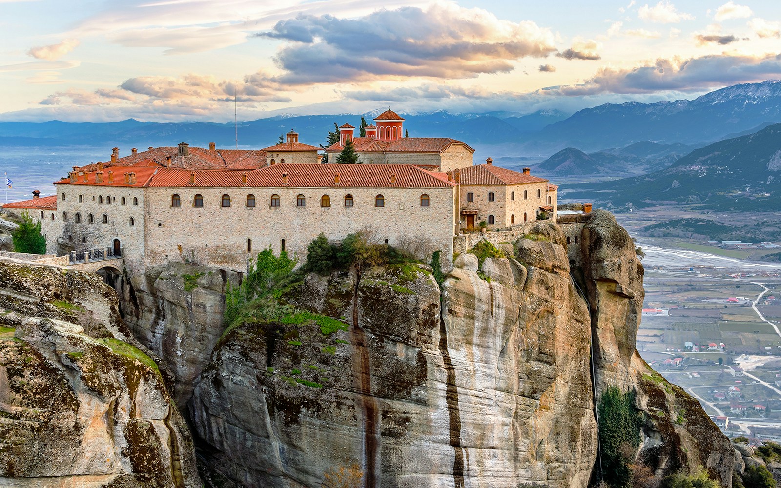 Meteora monastery perched on rock formation, view from 1-day train tour from Athens.