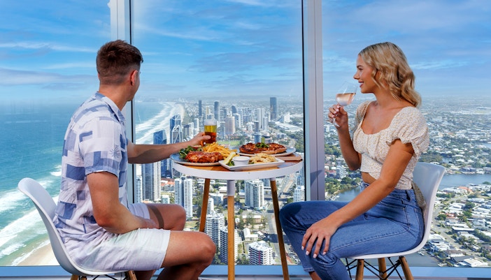 Couple enjoying pizza at SkyPoint Observation Deck Bistro