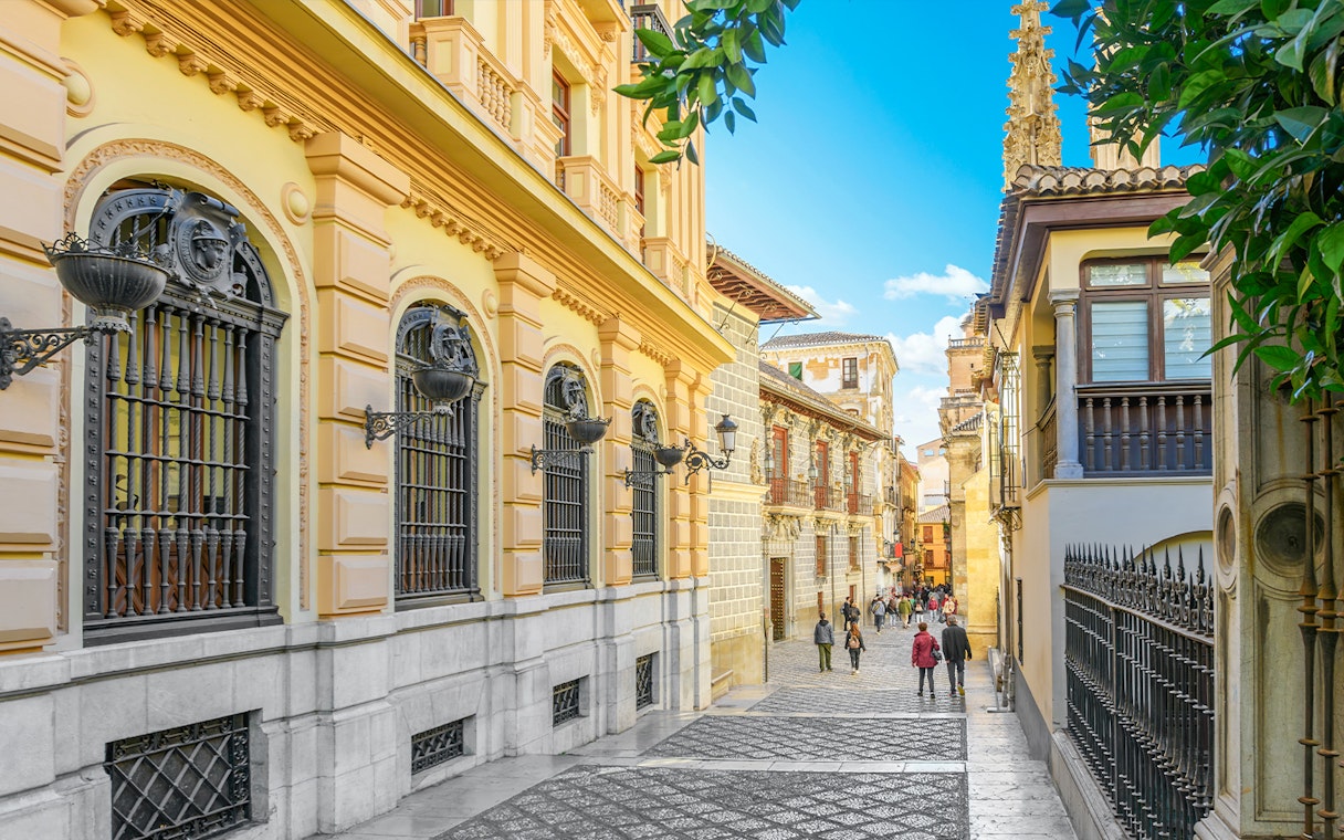 Calle Oficios street near Capilla Real de Granada, with ornate architecture in Granada, Spain.