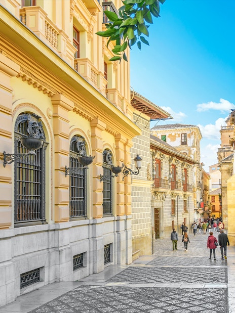 Calle Oficios street near Capilla Real de Granada, with ornate architecture in Granada, Spain.