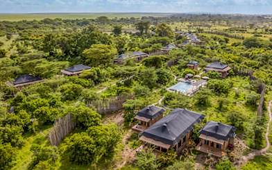 Aerial view of luxury tents and pool in Masai Mara safari camp, Kenya.