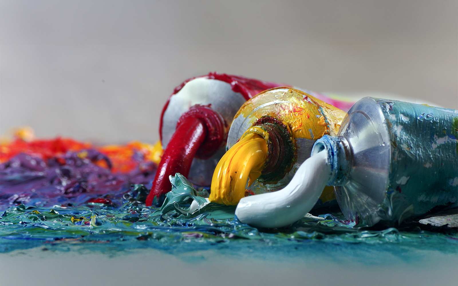 Tubes with art oil paint on a palette on a canvas