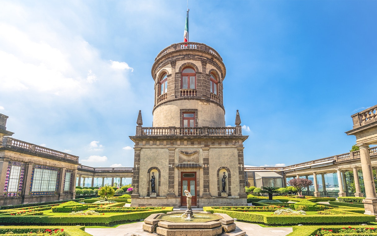 Chapultepec Castle tower in Mexico City with surrounding gardens and historic architecture.