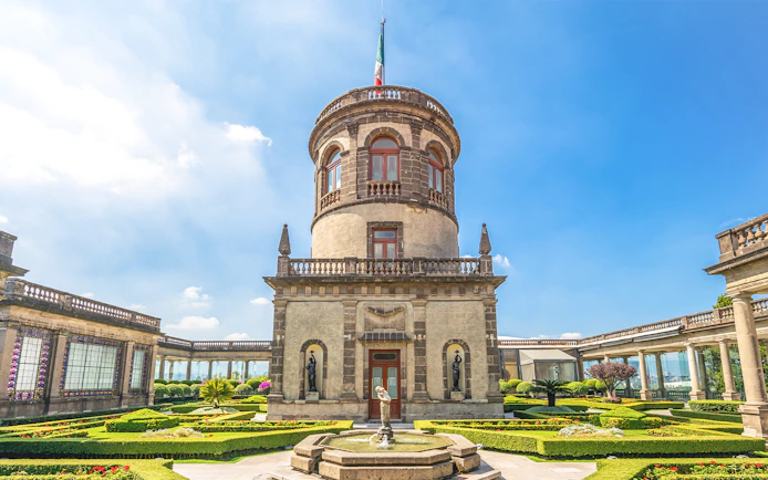 Chapultepec Castle tower in Mexico City with surrounding gardens and historic architecture.