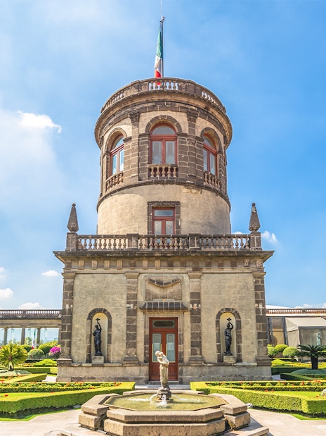 Chapultepec Castle tower in Mexico City with surrounding gardens and historic architecture.
