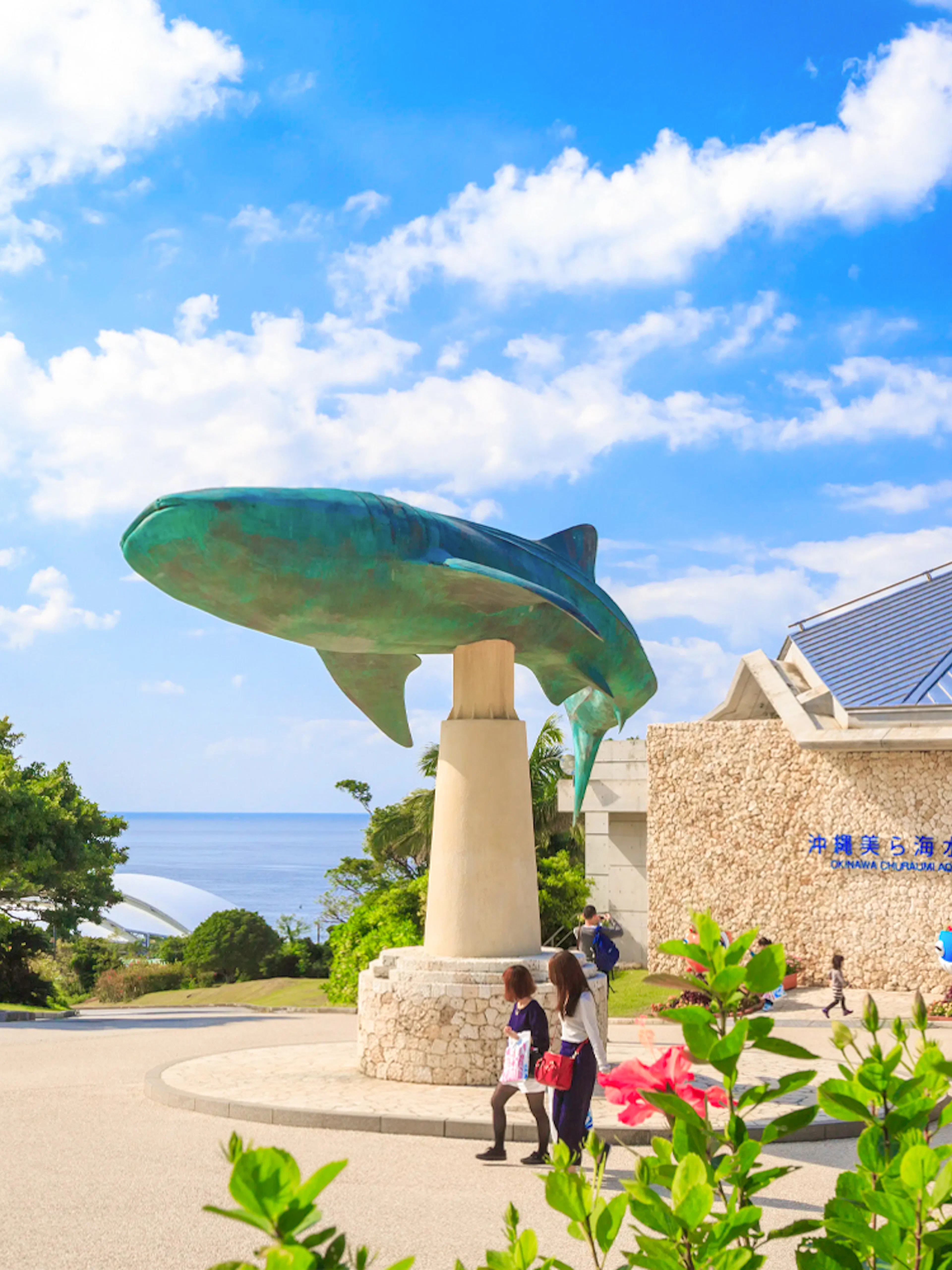 Churaumi Aquarium entrance with whale shark statue, Okinawa Hip Hop Bus Tour.