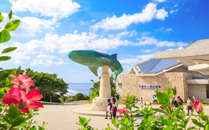 Churaumi Aquarium entrance with whale shark statue, Okinawa Hip Hop Bus Tour.