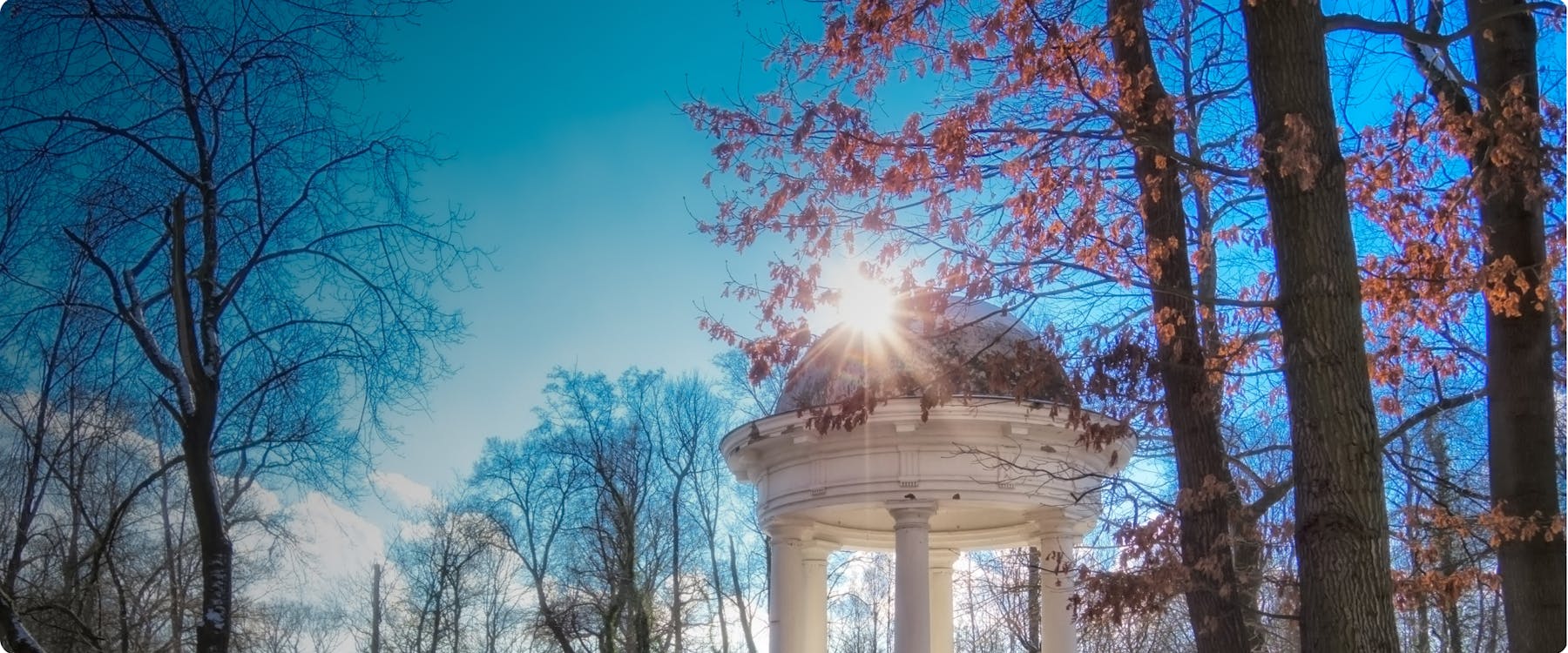 Sunlight through trees at a park pavilion in Leipzig.