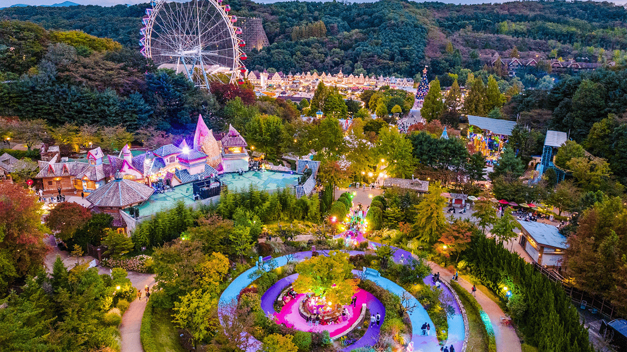 Aerial view of Everland theme park with Ferris wheel and colorful gardens in South Korea.