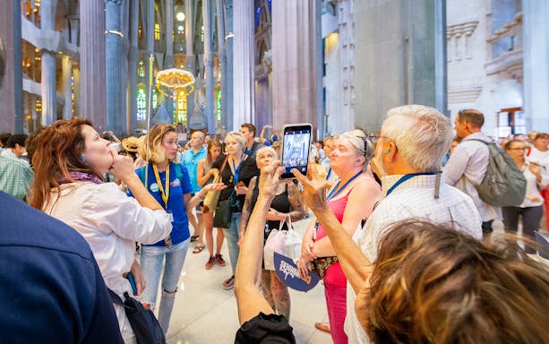Tour group inside Sagrada Familia, Barcelona, listening to a guide.