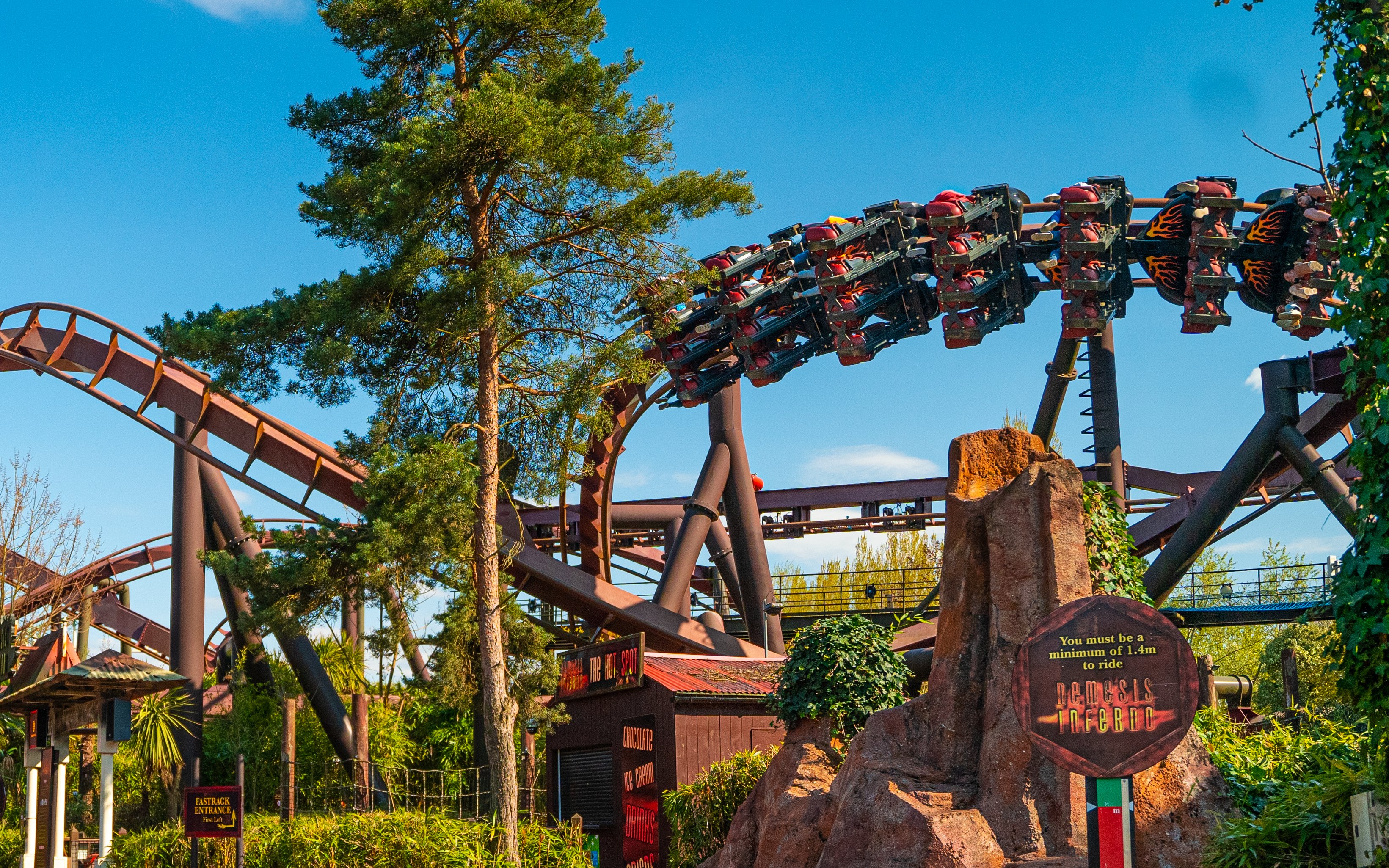 Roller coaster at Thorpe Park with riders on Nemesis Inferno loop.