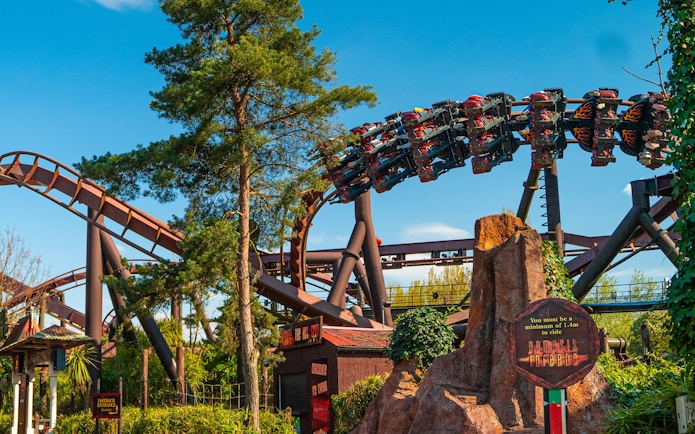 Roller coaster at Thorpe Park with riders on Nemesis Inferno loop.