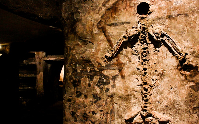 Visitors viewing skeletal remains in the Catacombs of San Gaudioso, Naples, Italy.