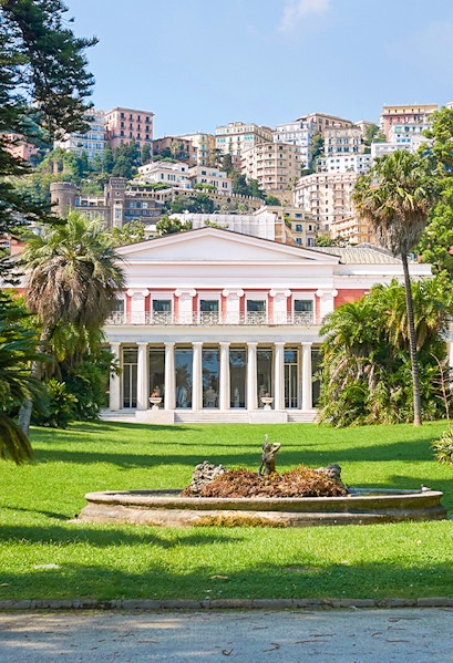 Villa Pignatelli in Naples with lush gardens and cityscape backdrop.