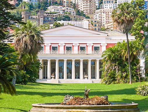 Villa Pignatelli in Naples with lush gardens and cityscape backdrop.