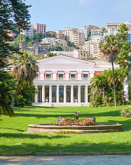 Villa Pignatelli in Naples with lush gardens and cityscape backdrop.
