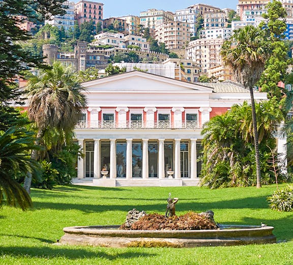 Villa Pignatelli in Naples with lush gardens and cityscape backdrop.