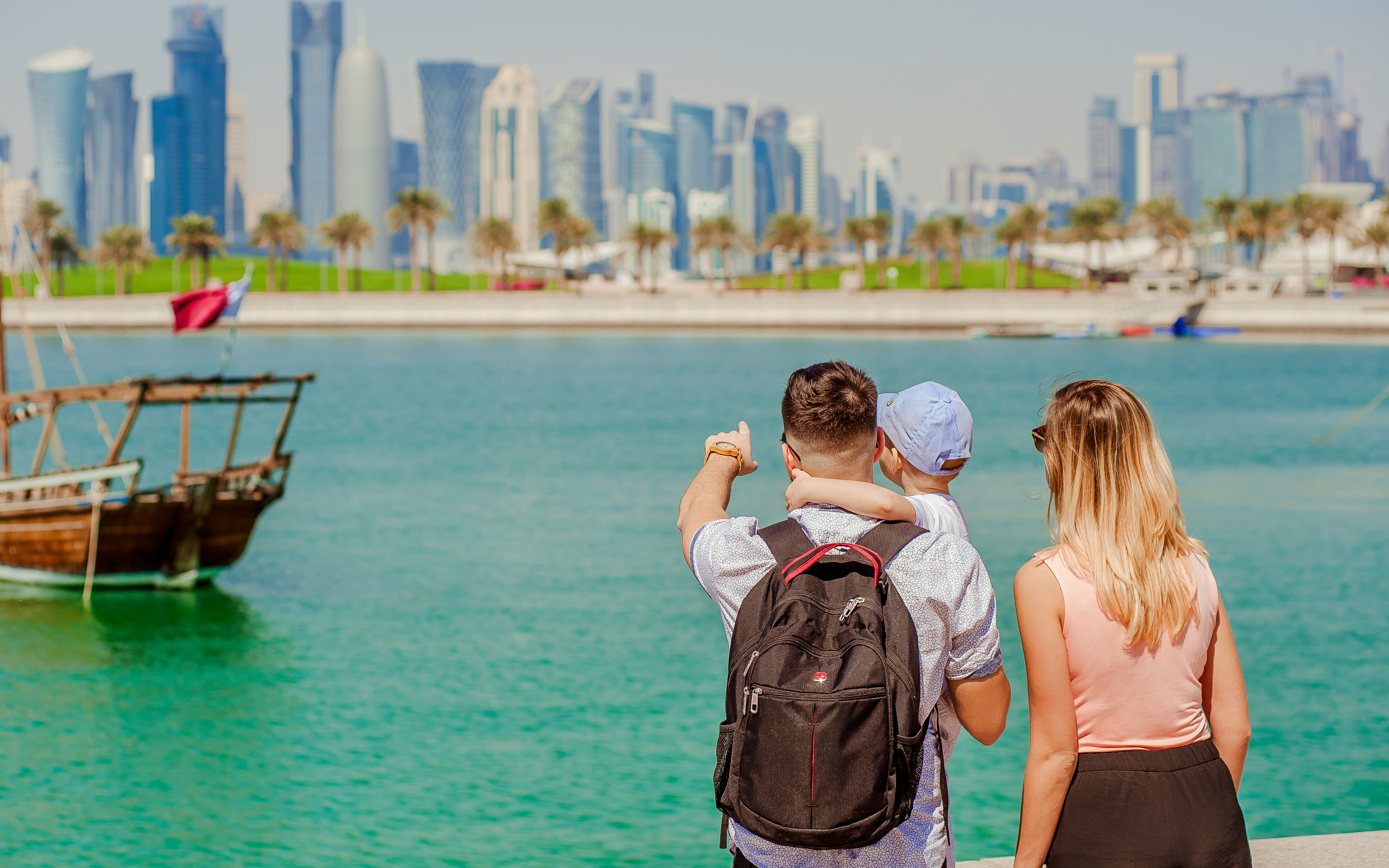 Family looks at the skyscrapers West Bay in Doha, Qatar