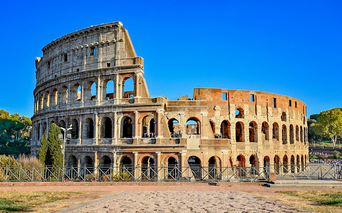 Colosseum in Rome, Italy under a clear blue sky.