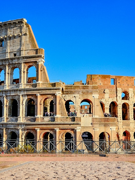 Colosseum in Rome, Italy under a clear blue sky.