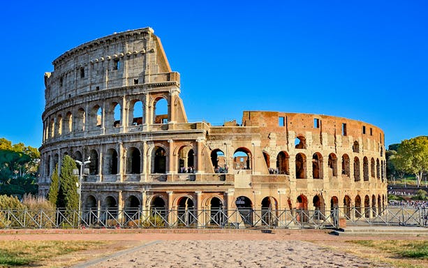 Colosseum in Rome, Italy under a clear blue sky.