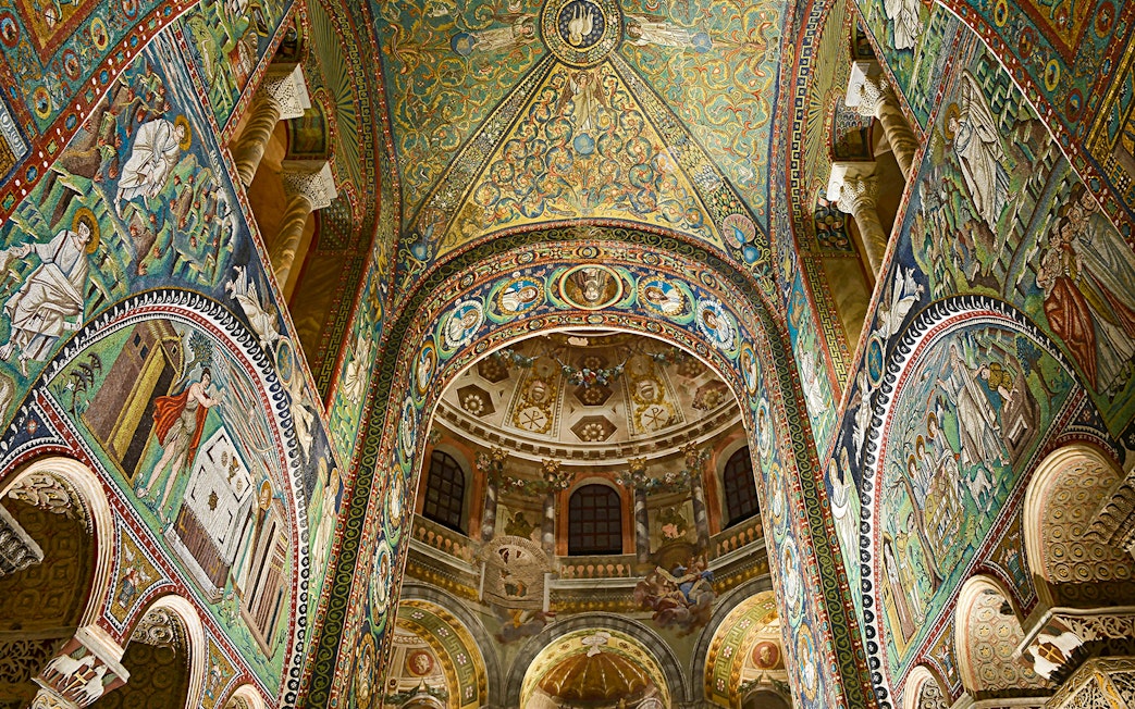 Intricate mosaics inside Basilica di San Vitale, Ravenna, Italy, showcasing vibrant religious scenes.