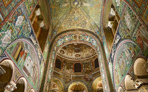 Intricate mosaics inside Basilica di San Vitale, Ravenna, Italy, showcasing vibrant religious scenes.