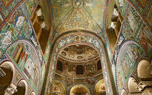 Intricate mosaics inside Basilica di San Vitale, Ravenna, Italy, showcasing vibrant religious scenes.