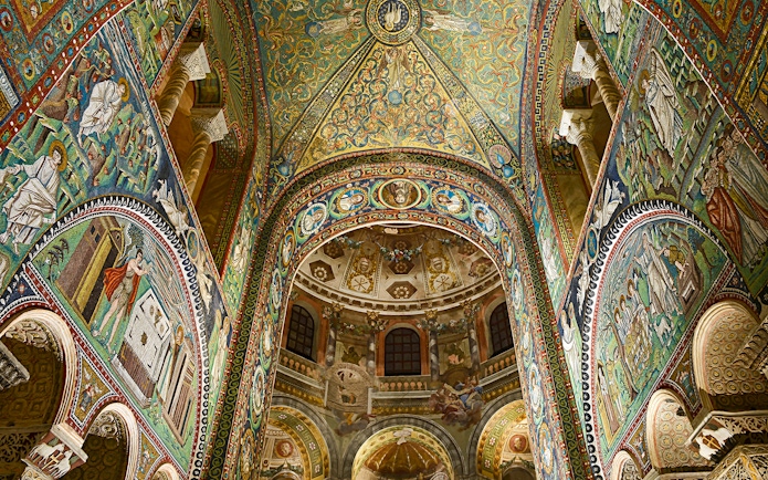 Intricate mosaics inside Basilica di San Vitale, Ravenna, Italy, showcasing vibrant religious scenes.