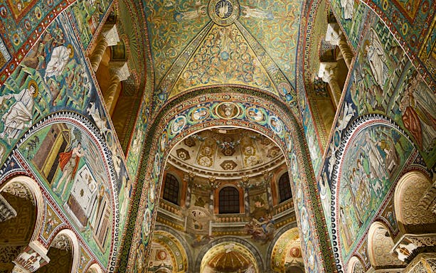 Intricate mosaics inside Basilica di San Vitale, Ravenna, Italy, showcasing vibrant religious scenes.